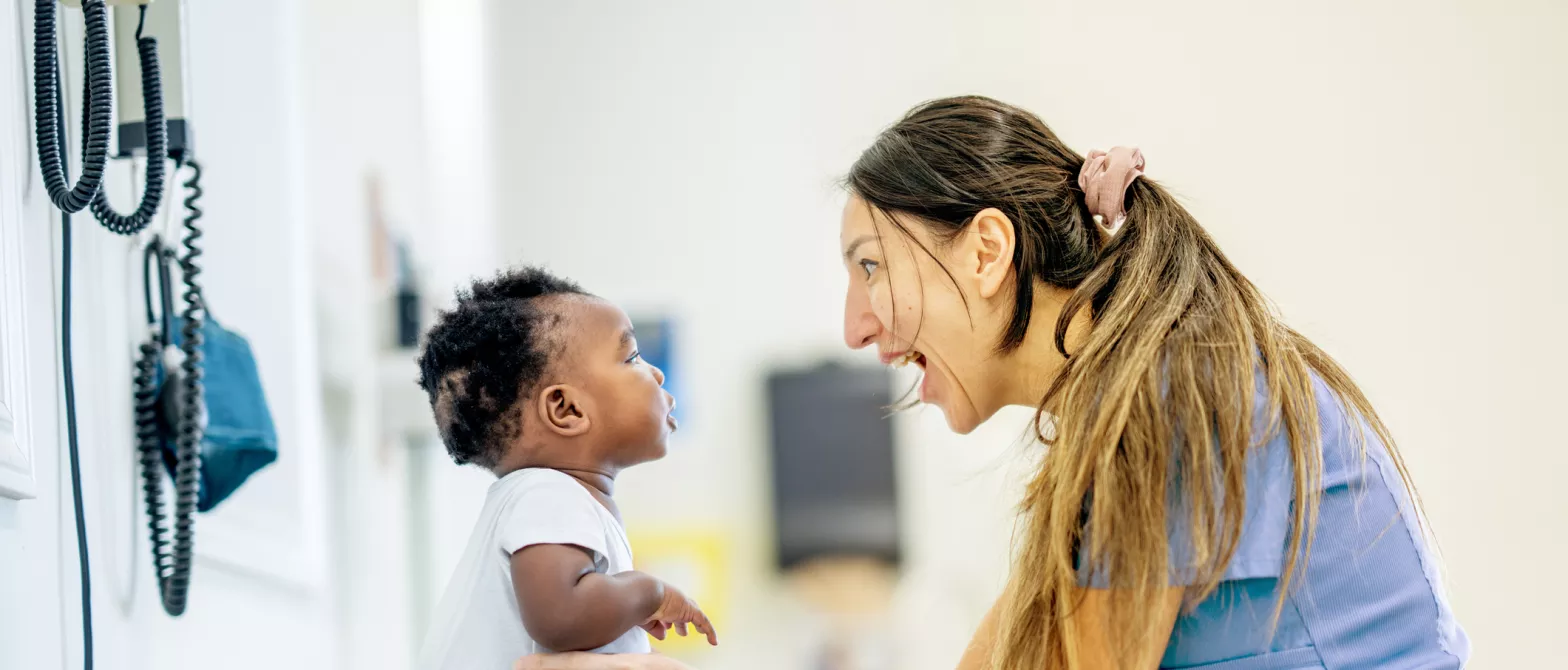 A nurse playing with an infant patient in BC Children's Hospital