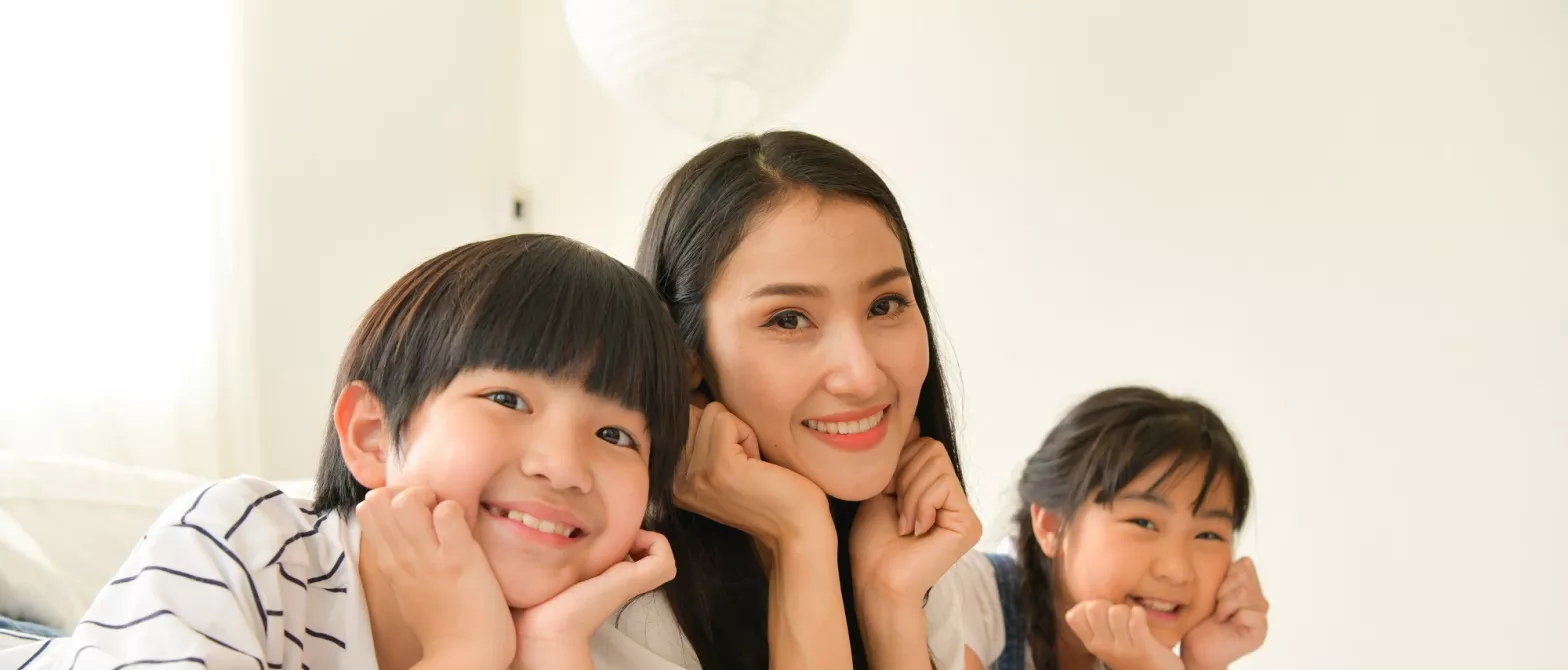 Mother and two children smiling