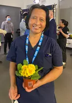 A BCCH housekeeper posing with a plant
