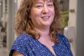 A social worker posing for a picture in a hallway