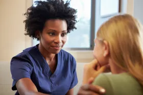 Nurse listening intently to patient