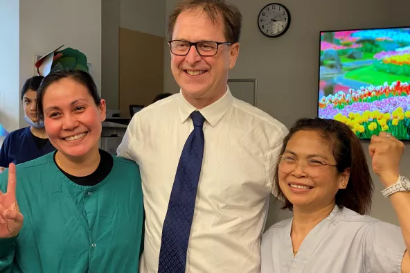 Adrian dix posing with BCCH staff members