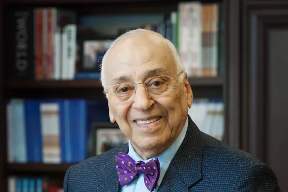 Dr. Mowafaghian posing in a library